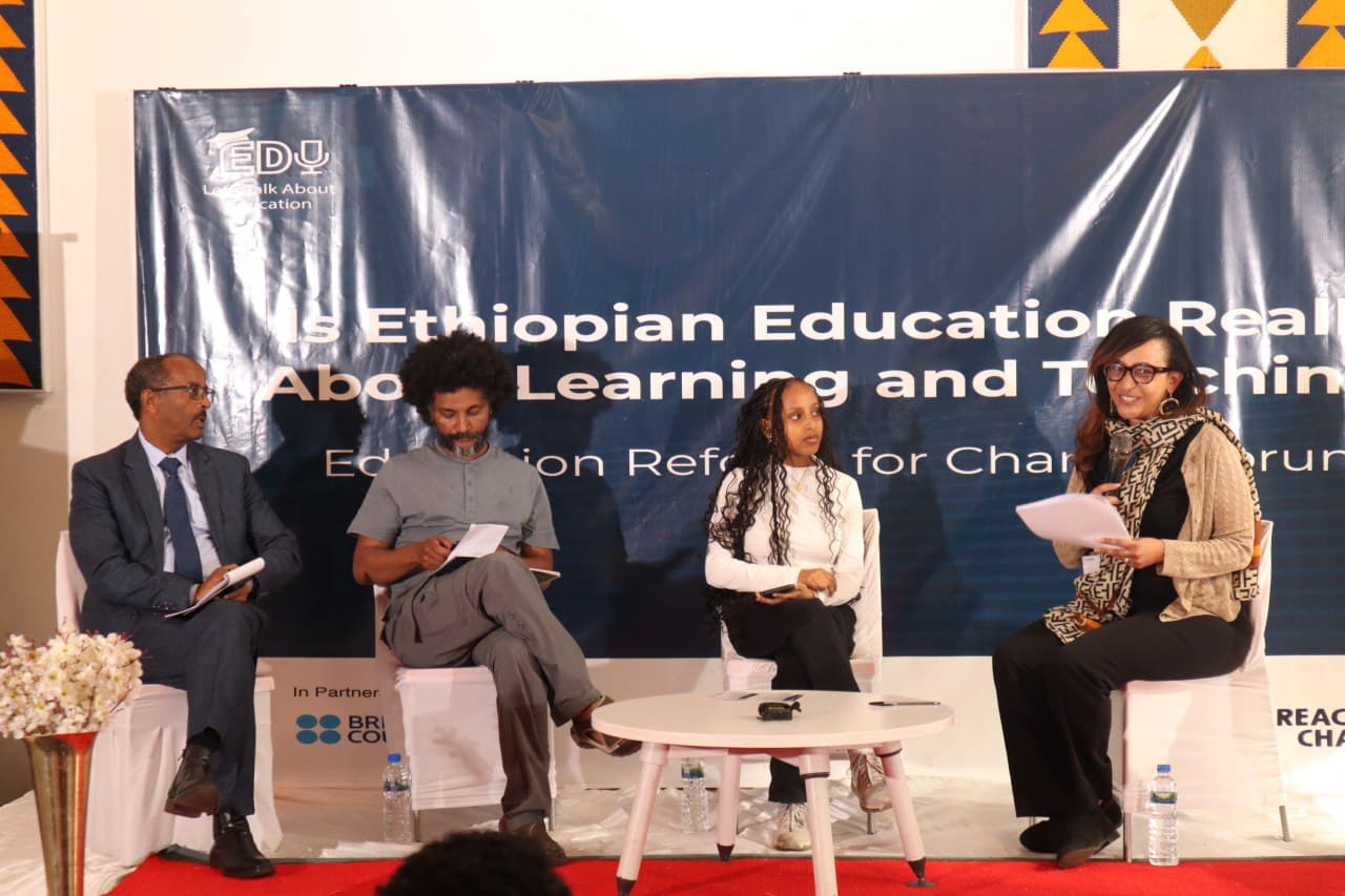Four panelists in discussion on stage at the forum