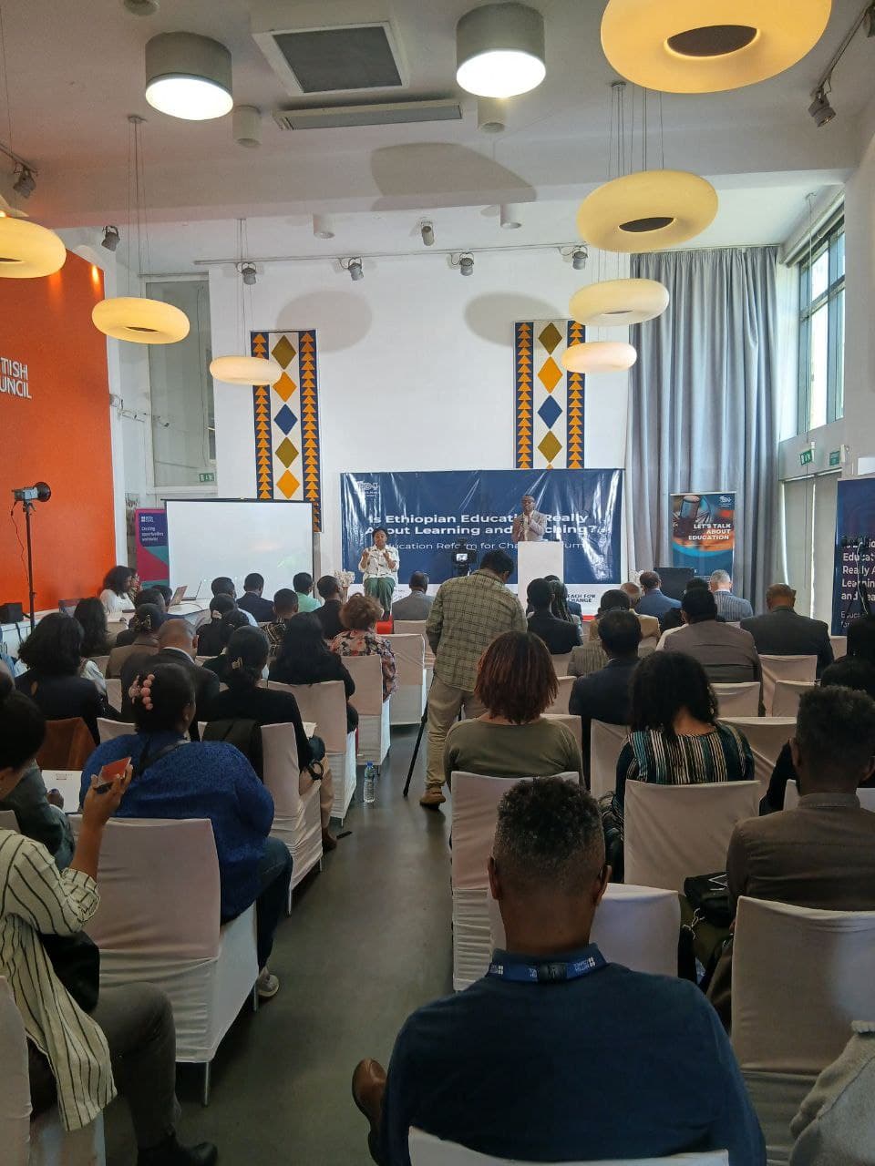 A full room listening to a speaker at the forum