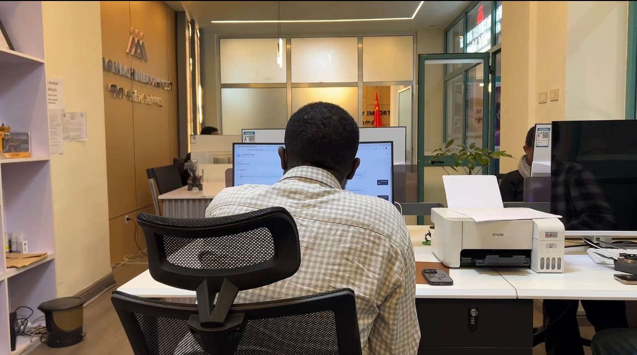 A Mag Machinery staff member working at a desk in the office